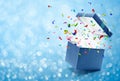 Confetti popping out from blue gift box Royalty Free Stock Photo