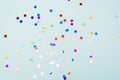 Confetti scattered on the light blue background. Bright dots on the background