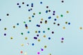 Confetti scattered on the light blue background. Bright dots on the background