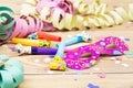 Confetti, streamers, mask and party blower on wood background Royalty Free Stock Photo