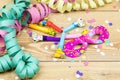 Confetti, streamers, mask and party blower on wood background Royalty Free Stock Photo