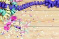 Confetti, streamers, mask and party blower on wood background Royalty Free Stock Photo