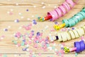 Confetti, streamers and party blower on wood background Royalty Free Stock Photo