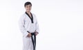 Confidence athlete strong young man wear uniform taekwondo holding black belt in own hand while standing over isolated white