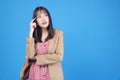 Confidence business positive Asian young woman thinking have good idea holding finger on head looking at copy space standing over Royalty Free Stock Photo