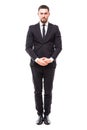 Confidence and charisma. Full length of smiling young bearded man in formalwear keeping hands crossed and looking at camera agains Royalty Free Stock Photo