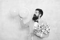 Confidence and charisma. Man bearded gentleman suit bow tie hold air balloons and bouquet. Gentleman making romantic