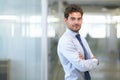 Confidence in the corporate world. a handsome young businessman standing in the office. Royalty Free Stock Photo