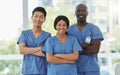 Confidence, crossed arms and portrait of team of doctors standing in the hallway of hospital. Happy, diversity and group Royalty Free Stock Photo