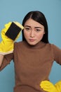 Confidence serious asian young houseworker from chores