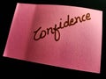 confidence text presented on pink paper slip isolates Royalty Free Stock Photo