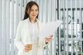 Confidence woman concept, Businesswoman drinking coffee and reading financial document in office Royalty Free Stock Photo