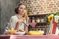 confident adult housewife talking by vintage wired phone Royalty Free Stock Photo