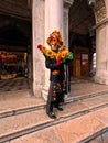 Confident adult male dressed in a vibrant colored costume during the Carnival of Venice