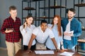 Confident African-American business team leader stading surrounded by colleagues and looking confidently at camera. Royalty Free Stock Photo