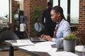 Confident african american business woman analyzing project financial statistics. Royalty Free Stock Photo