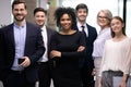 Confident african american business woman boss with happy businesspeople team