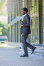 African american businessman in suit walking on stairs of office building Royalty Free Stock Photo