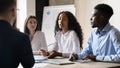 Confident African American businesswoman speaking at corporate meeting in boardroom