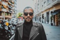 Confident african american man wearing on sunglasses and black leather jacket outdoor. Street wear fashion black man Royalty Free Stock Photo