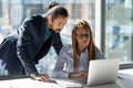 Confident African American mentor businessman training new employee using laptop Royalty Free Stock Photo