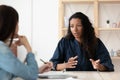 Confident African American woman candidate speaking at job interview Royalty Free Stock Photo