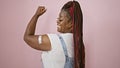 Confident african american woman, sporting braids and a band aid on her arm, exuding joy with a strong gesture
