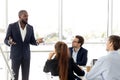 African business coach in suit giving presentation to clients Royalty Free Stock Photo