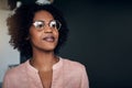 Confident African businesswoman standing alone in a modern office Royalty Free Stock Photo