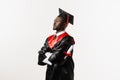 Confident african man bachelor in graduation robe and cap on white background. Happy and funny african graduate man Royalty Free Stock Photo