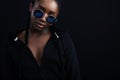 Confident african woman with dark skin wearing round sunglasses Royalty Free Stock Photo