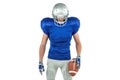 Confident American football player looking down Royalty Free Stock Photo
