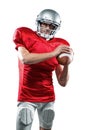 Confident American football player in red jersey holding ball Royalty Free Stock Photo