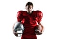 Confident American football player in red jersey holding helmet and ball Royalty Free Stock Photo