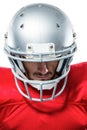 Confident American football player in red jersey looking down Royalty Free Stock Photo