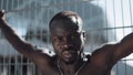 Confident and angry african american man looking at camera - outdoor. Drug trafficker, prisoner or criminal man standing