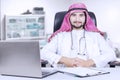 Confident Arabian physician sits at workplace Royalty Free Stock Photo