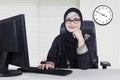 Confident Arabian worker sits in office