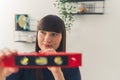 Confident architect caucasian woman with a spirit level in the foreground. Royalty Free Stock Photo