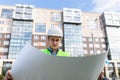 Confident architect holding rolled up blueprints at construction site outdoors Royalty Free Stock Photo