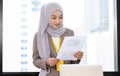 Confident Asia Muslim Islam businesswomen executive dressed in the religious veil, working in the modern office and standing in