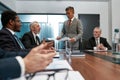 Confident asian businessman in formal wear discussing project results with multicultural team while having a meeting in Royalty Free Stock Photo