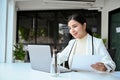 Confident Asian businesswoman or female manager working at her office desk, using laptop Royalty Free Stock Photo