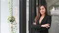 Confident asian businesswoman in formalwear standing with arms crossed in modern office Royalty Free Stock Photo