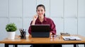 Confident asian businesswoman sitting in office and smiling to camera Royalty Free Stock Photo