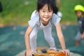 Confident asian chinese girl child climbing rock wall Royalty Free Stock Photo