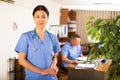 Confident Asian female doctor standing in medical office Royalty Free Stock Photo