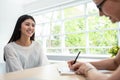 Confident Asian female employee is smiling during the job interview. .