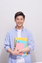 Confident asian handsome student holding books Royalty Free Stock Photo