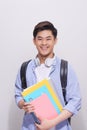 Confident asian handsome student holding books Royalty Free Stock Photo